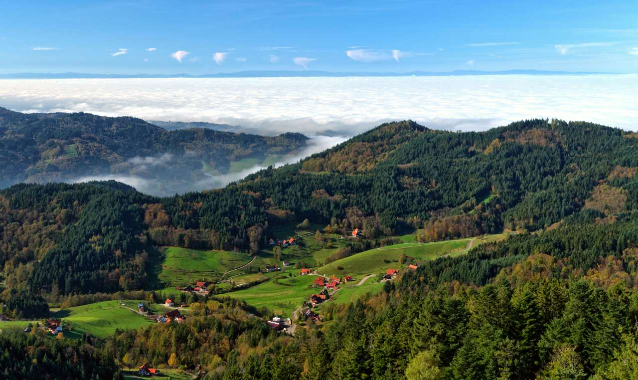The Black Forest is a large forested mountain range in the state of Baden-Württemberg in southwest Germany, bounded by the Rhine Valley to the west and south and close to the borders with France and Switzerland.