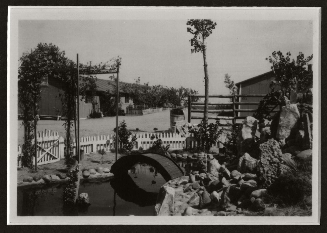 black and white image of a Japanese styled garden with a small koi pond.