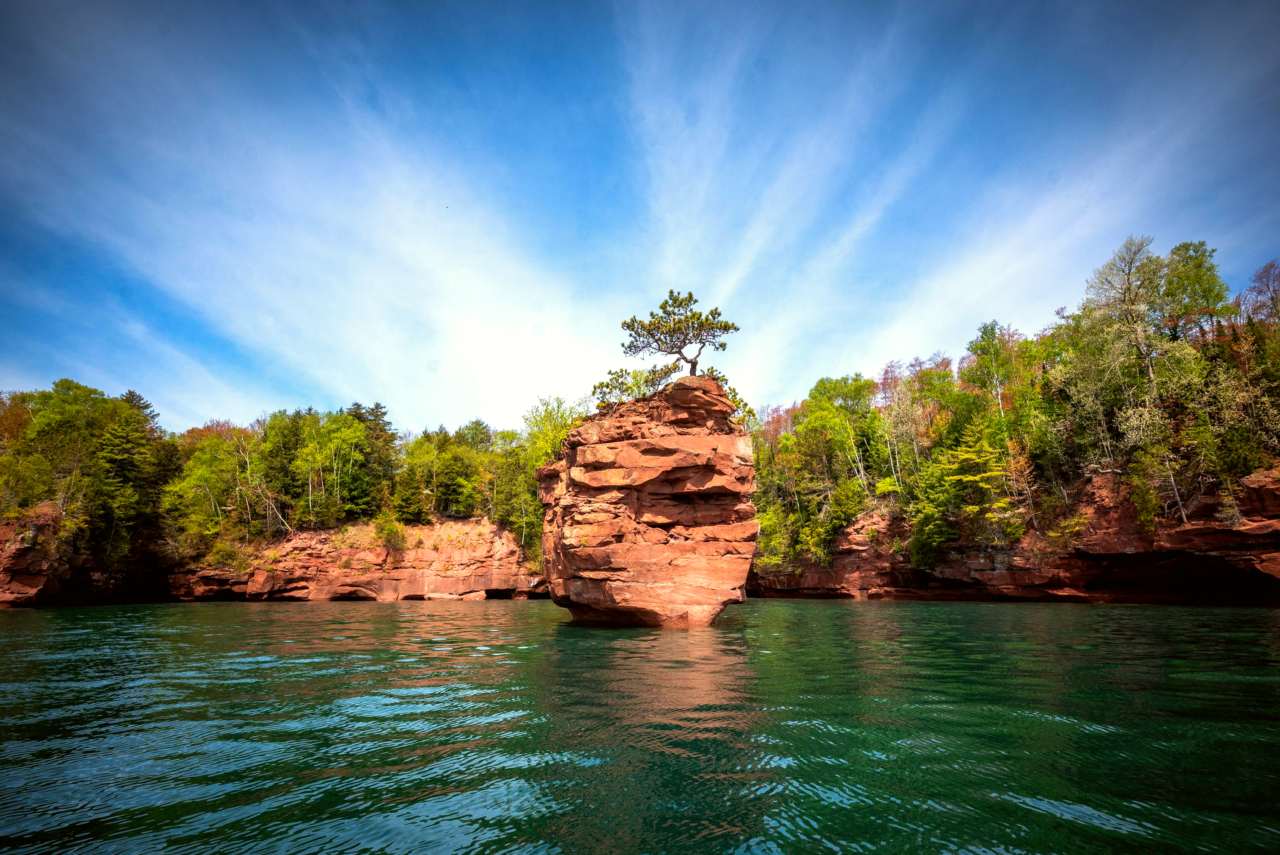 Photograph of Lake Superior sandstone rock stack under a blue sky.