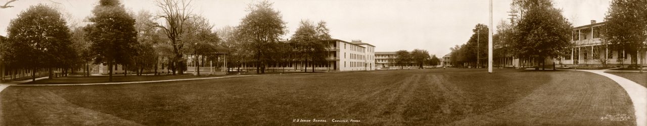 Historic black and white image of a large boarding school campus