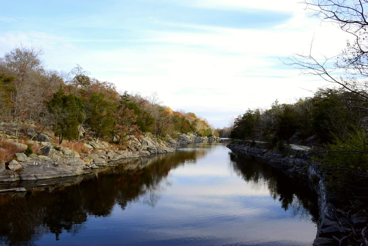 A bright blue sky reflects off clear water