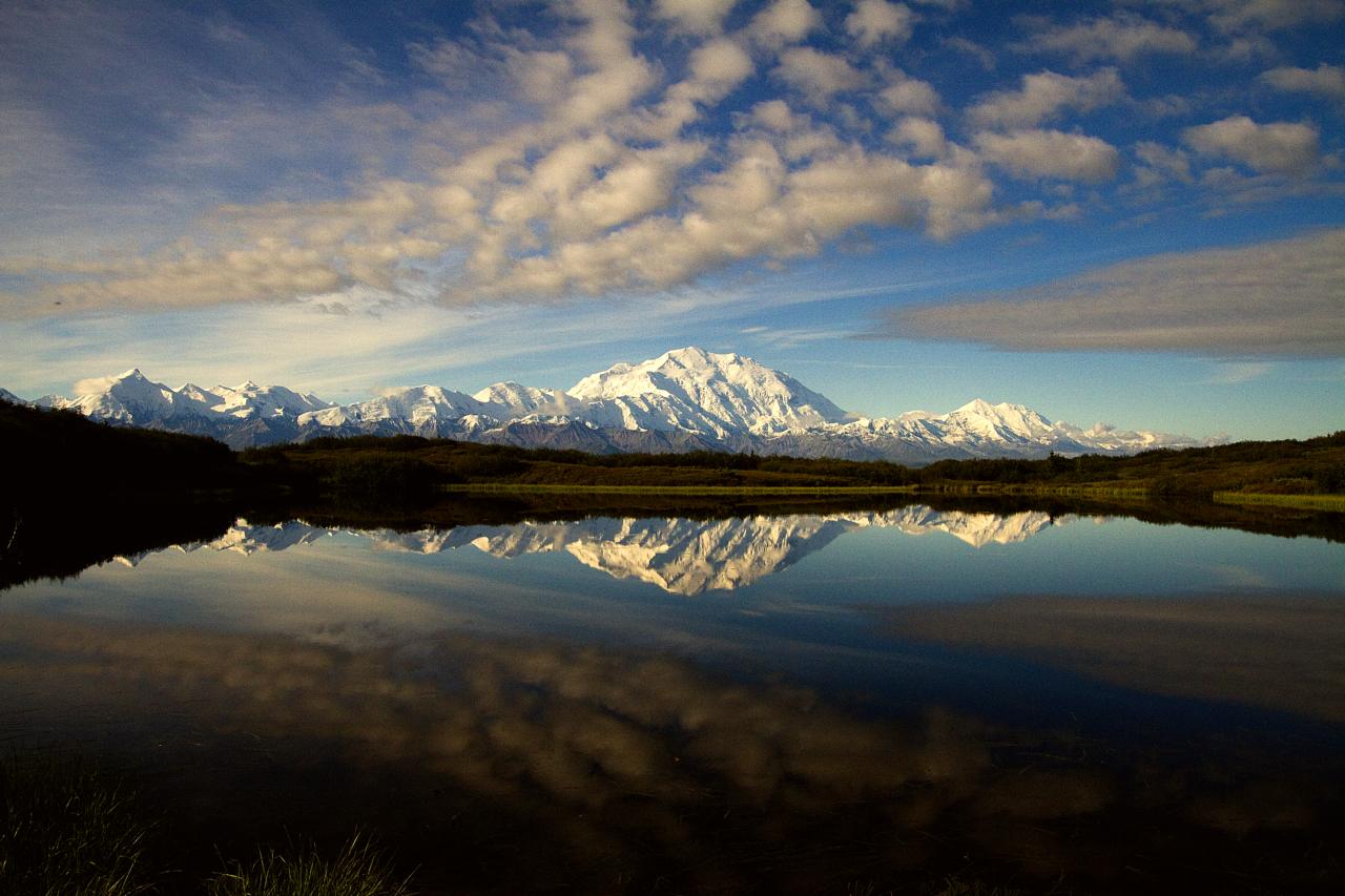 snowy mountains reflected in a pond