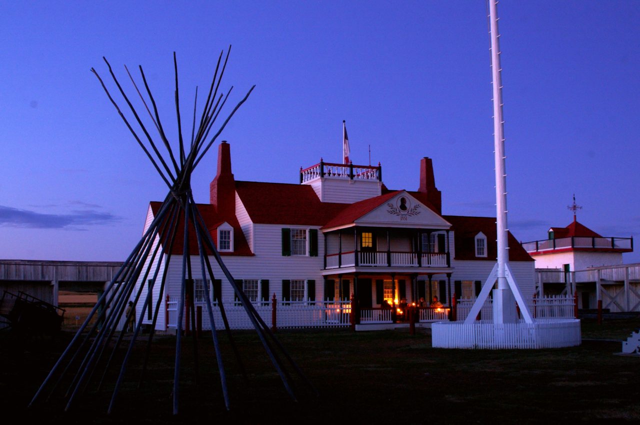 Candles illuminate the Bourgeois House porch at dusk