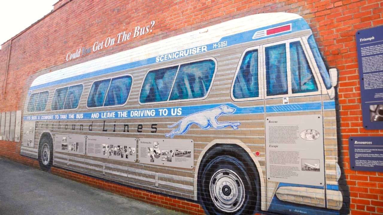 Colored Greyhound mural with historical information about the Freedom Riders