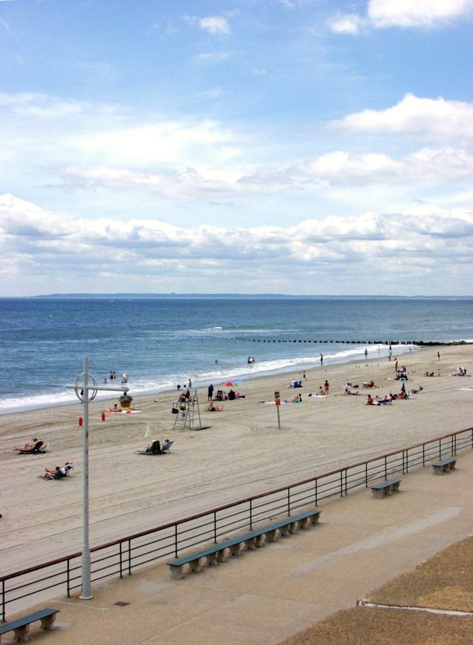 Visitors enjoying the sun and sand at Jacob Riis Park