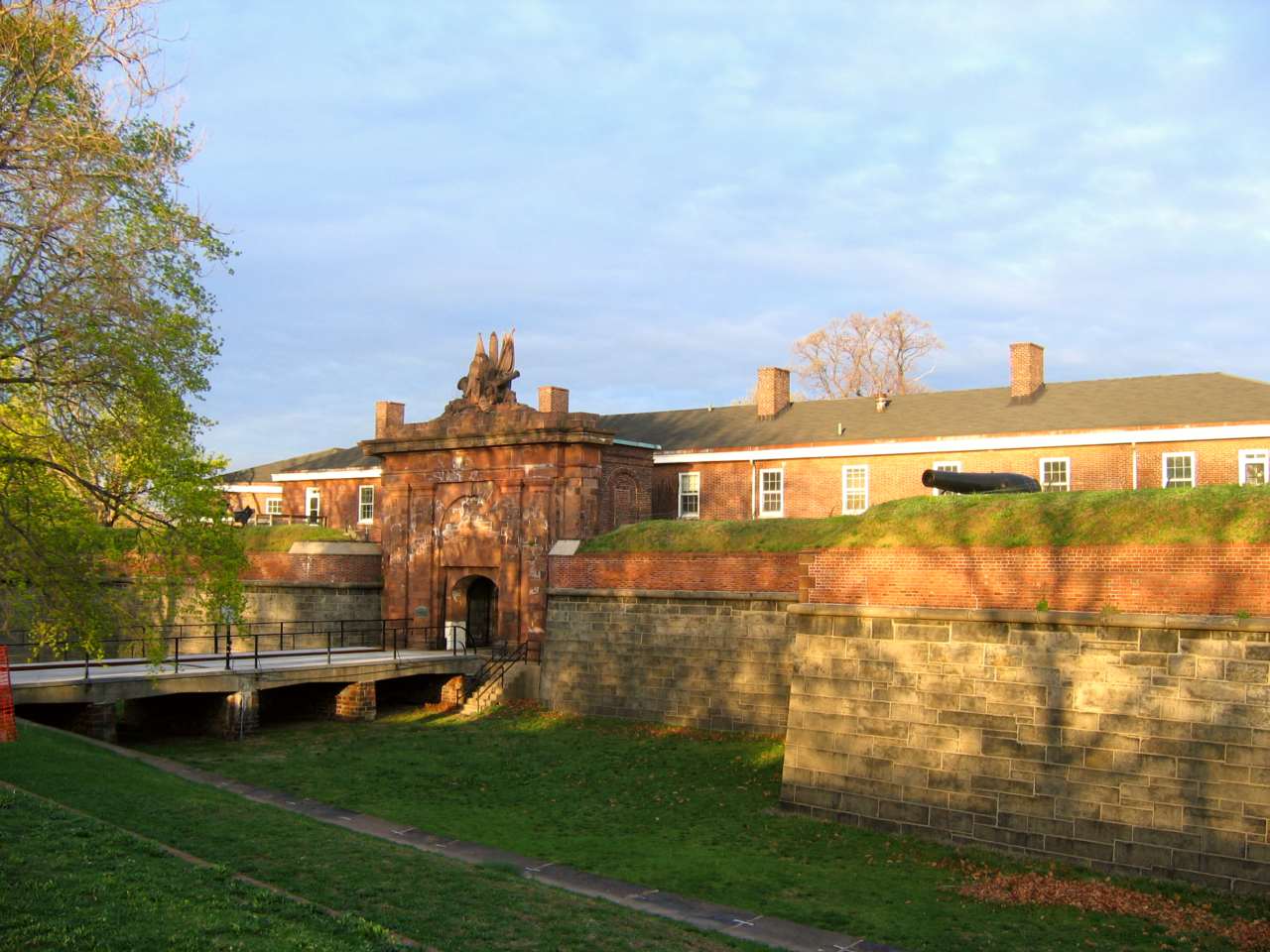 Bridge over dry moat leading into a gated fort.