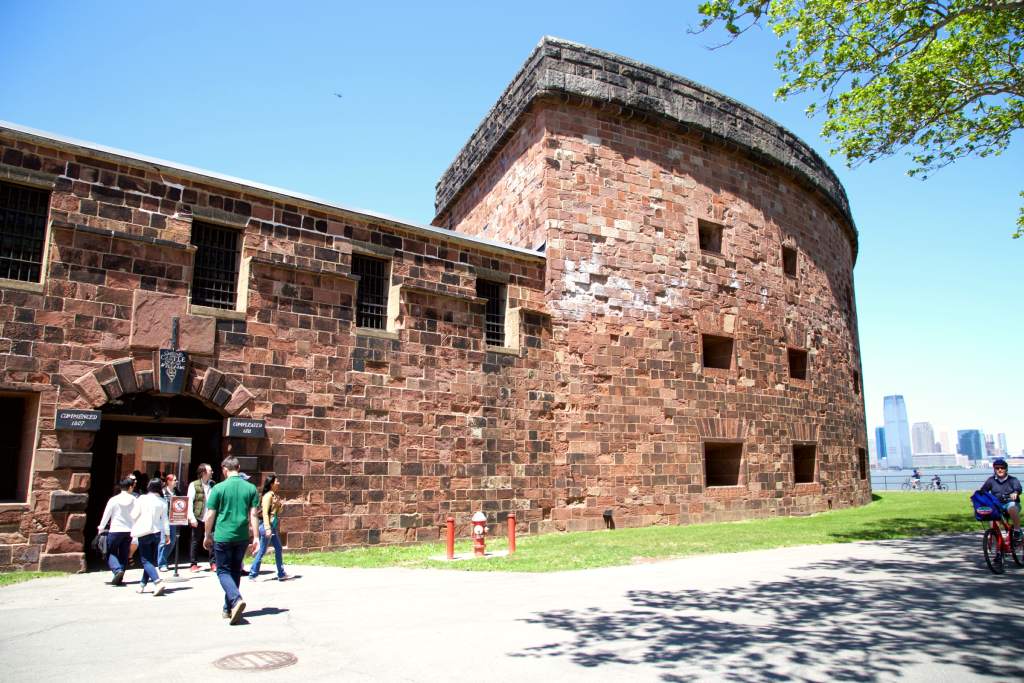 Front of sandstone brick fort with arched entrance way.