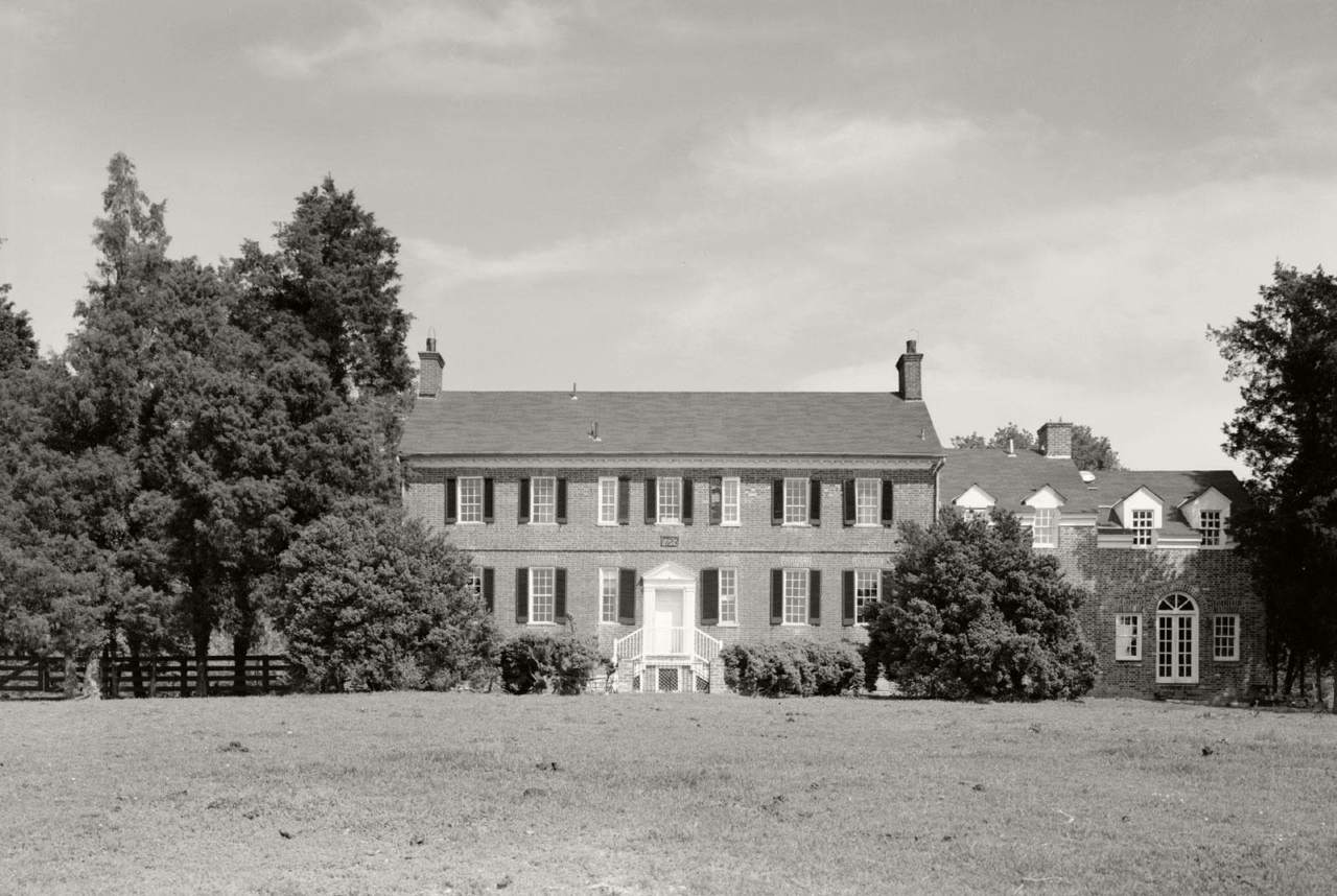 black and white photo of a large two story brick manor