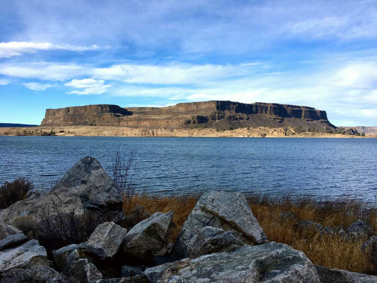 Large butte with lake in the foreground