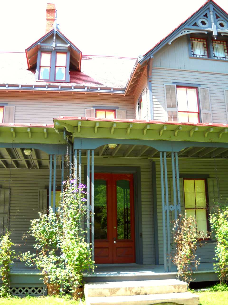Front porch of Garfield home showing red front door