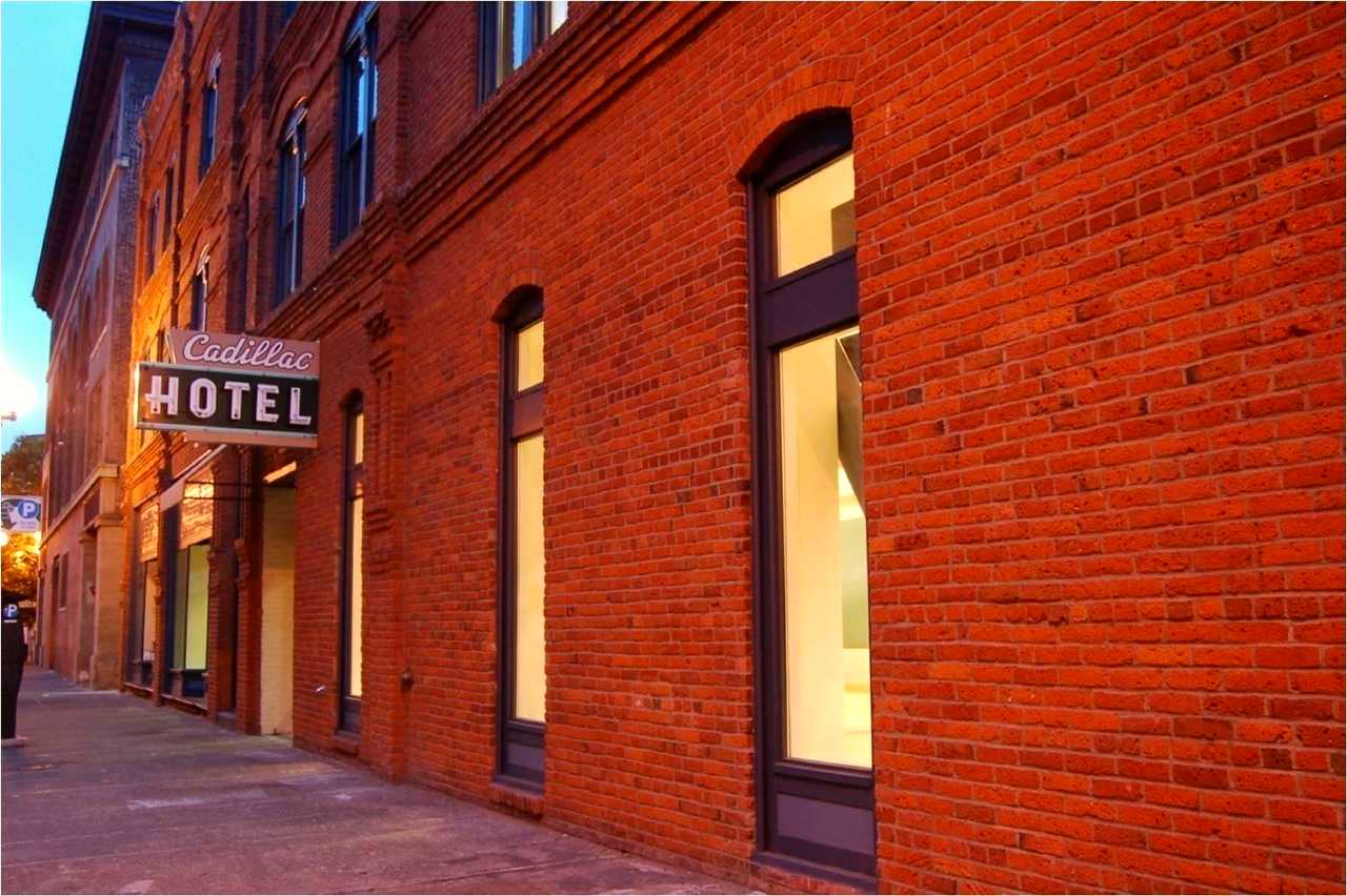 Large brick wall with glass windows.