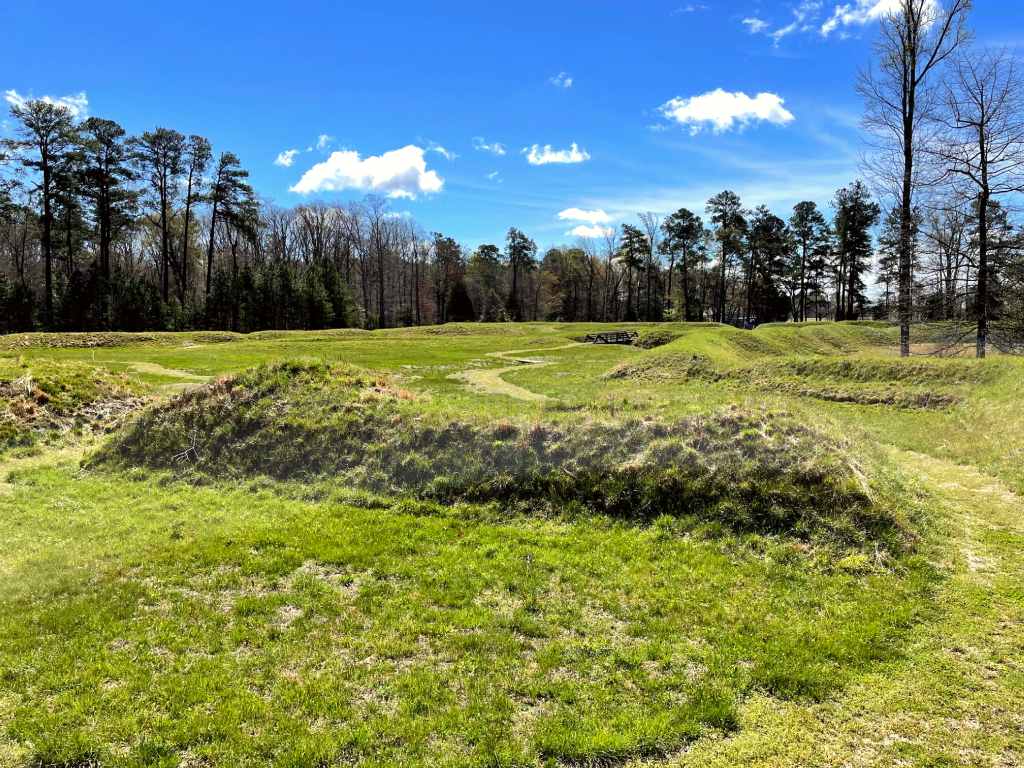 Earthworks covered in green grass.
