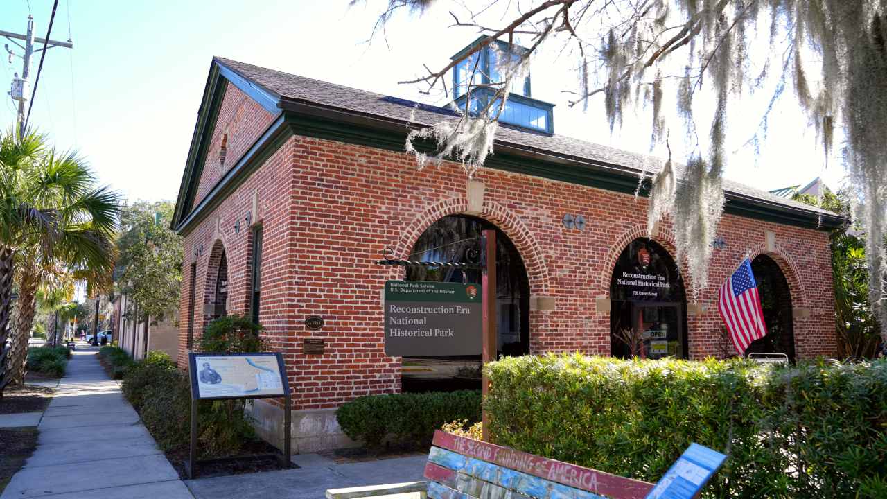 A one story brick building with large arched windows
