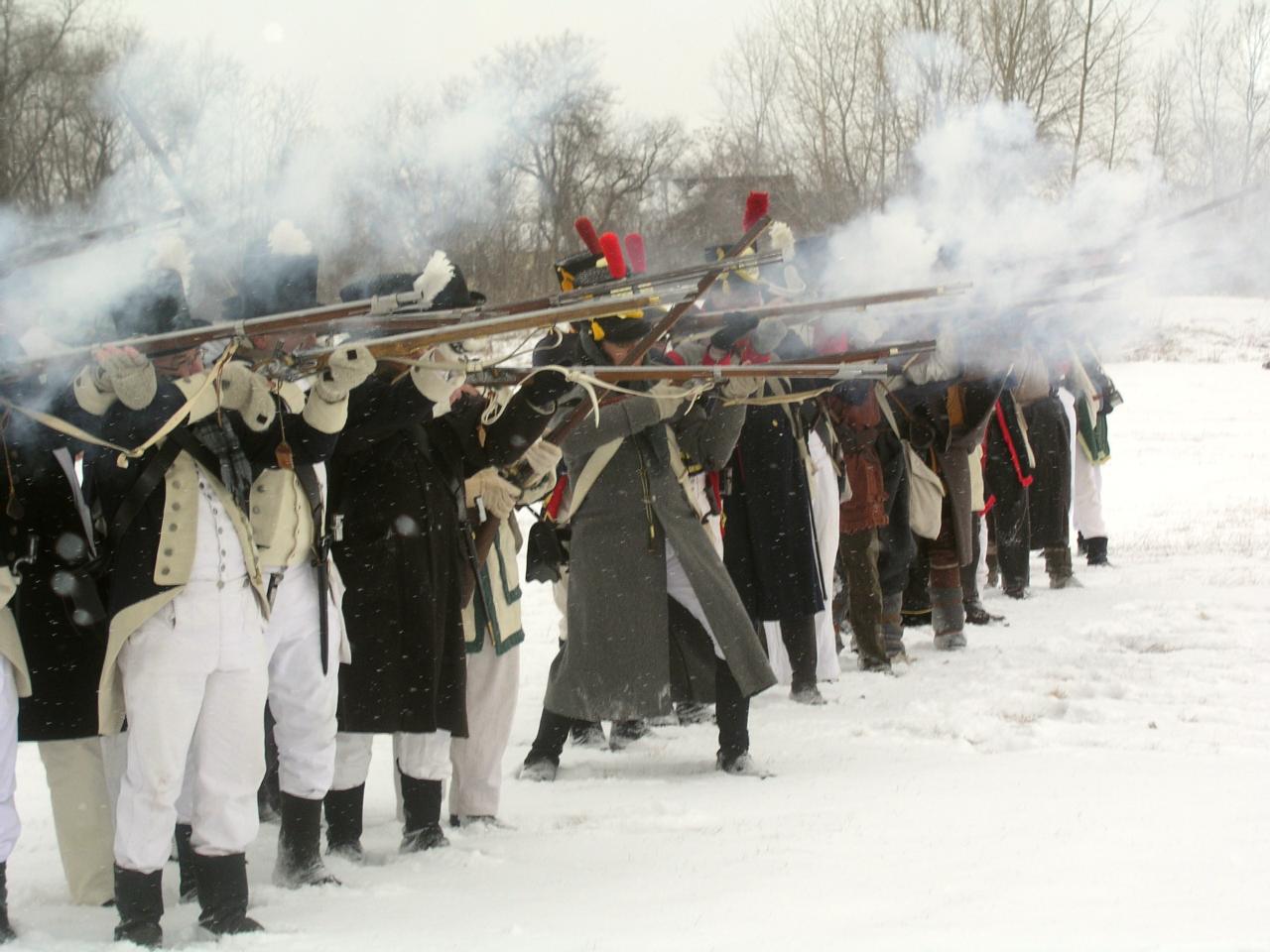 re-enactors firing in a battle line