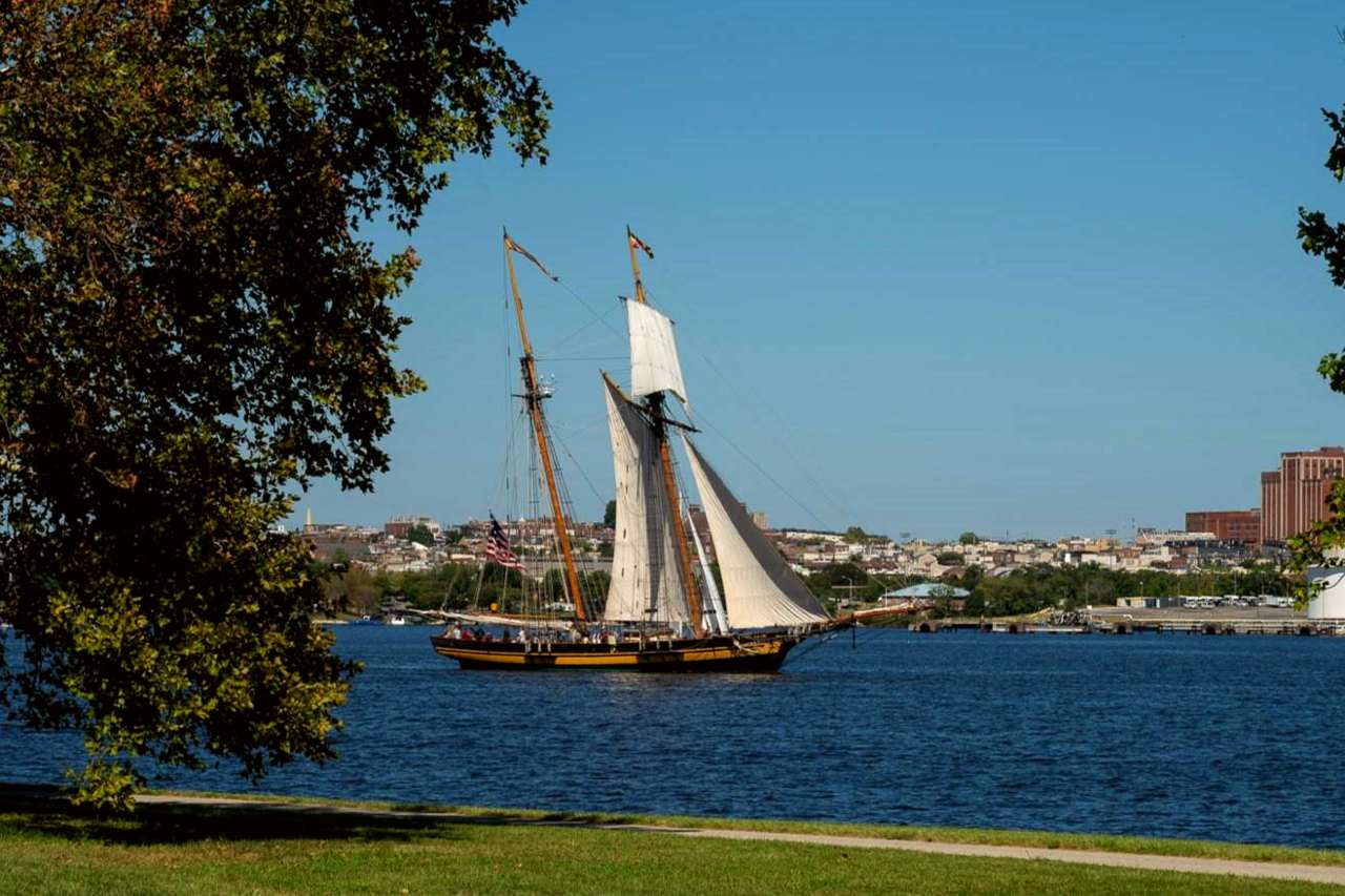 A tall ship sails on the water.