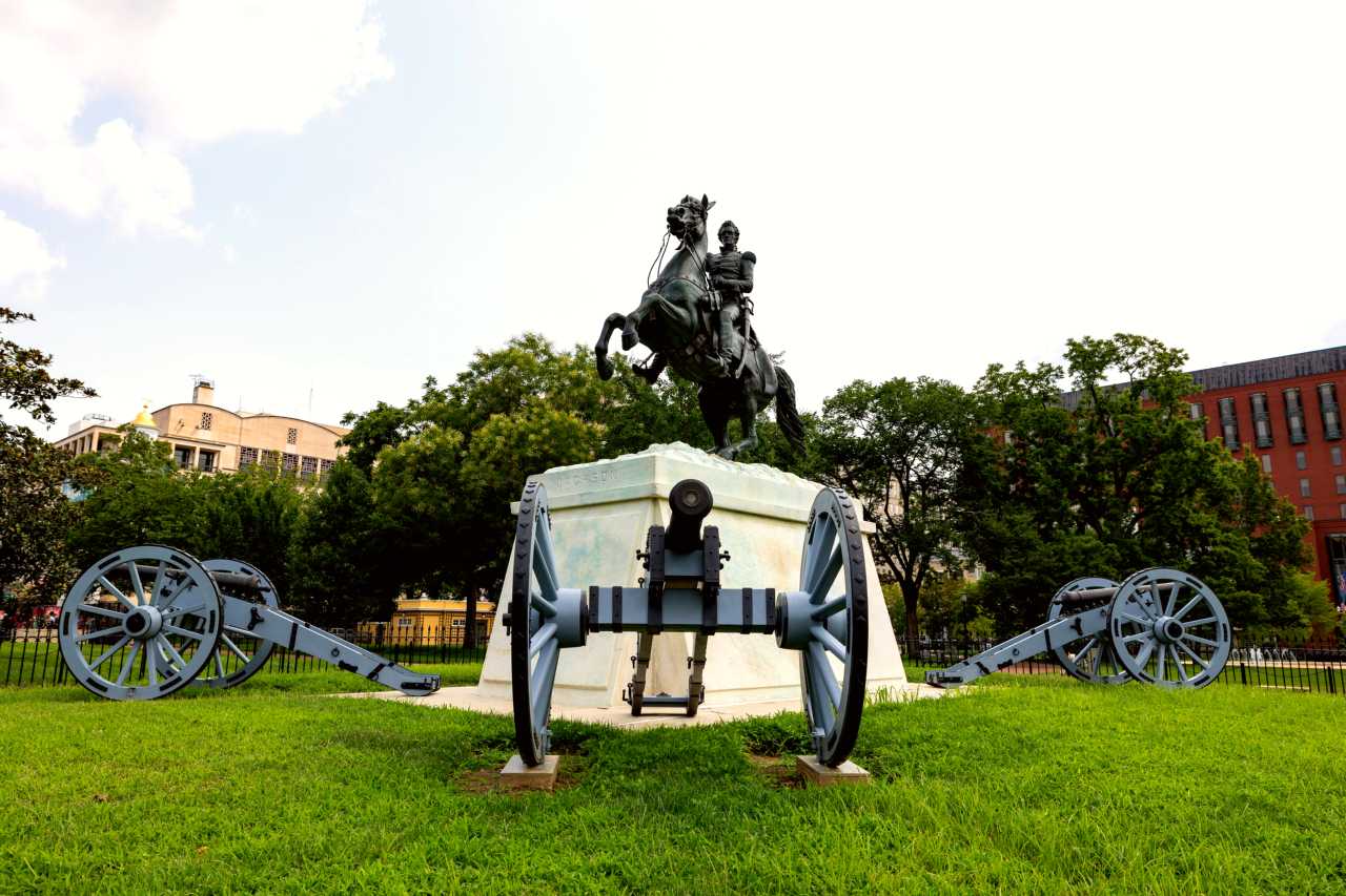A bronze statue of Andrew Jackson on horseback surrounded by cannons
