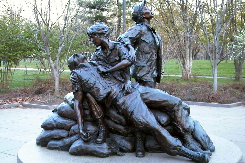 Bronze statue of three women with a wounded soldier.