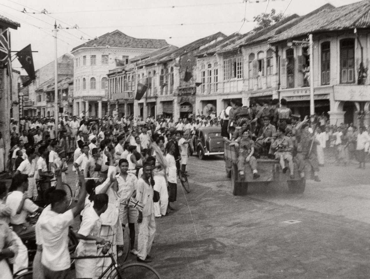 Royal Marines parading through a liberated George Town, 3 September 1945.
