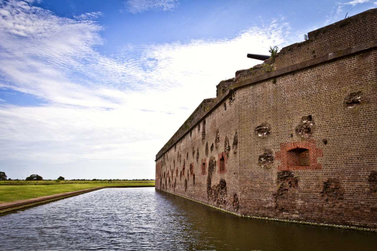 The red masonry walls of Fort Pulaski still show battle damage over 150 years later.
