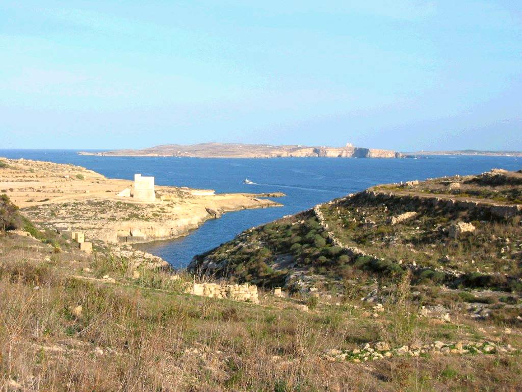 View of Mġarr ix-Xini, with Comino and mainland Malta in the background.