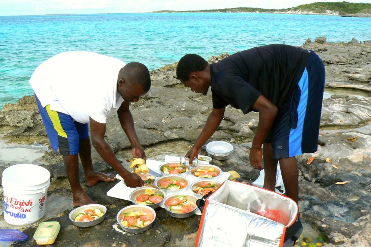 Men preparing a meal with caught fish