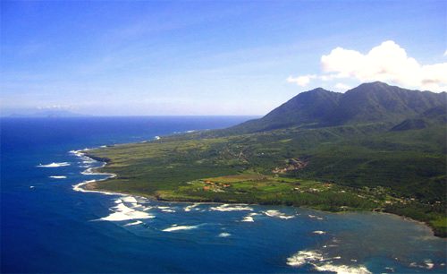 The east coast of Nevis, partially protected by coral reefs with Long Haul Bay visible in the foreground