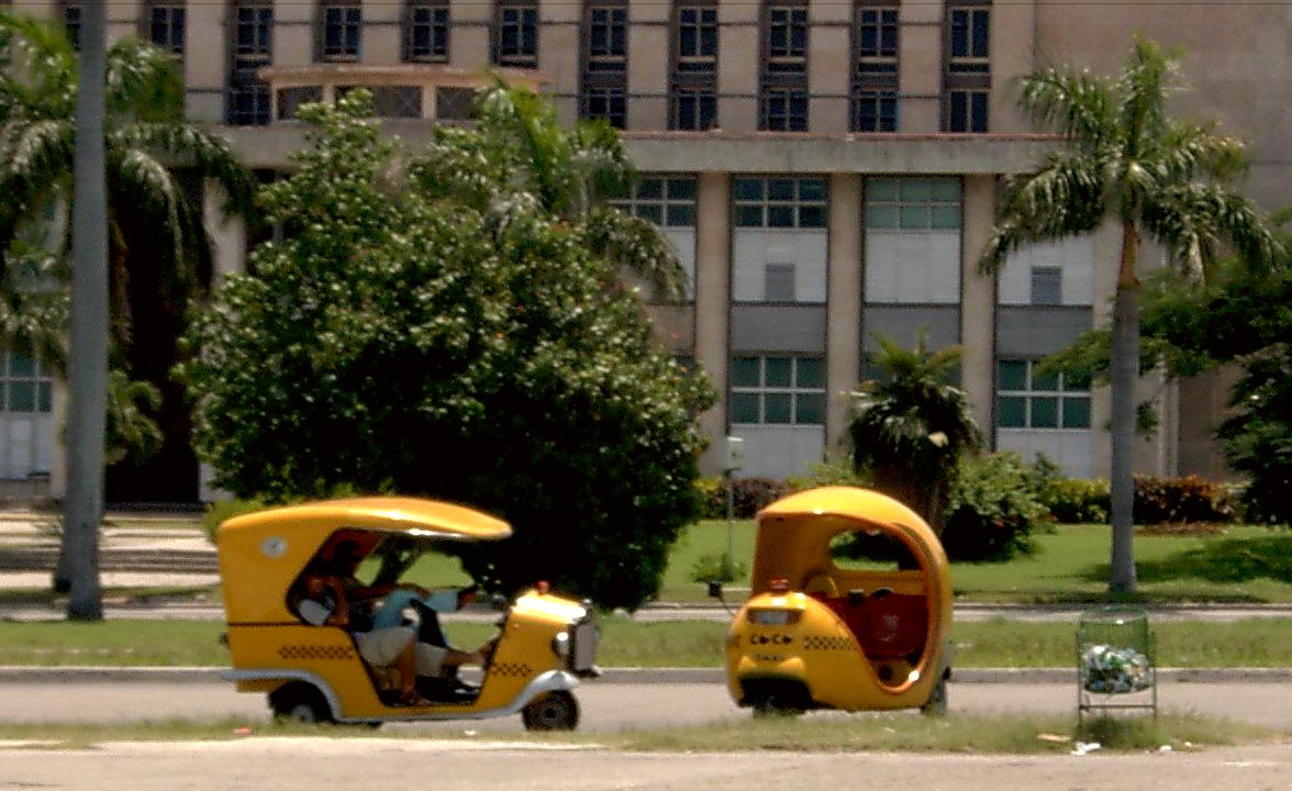"Cocotaxis" in Plaza de la Revolución, Havana. Because of the rapid growth of tourism in Cuba, taxi drivers can earn more than lawyers and doctors.