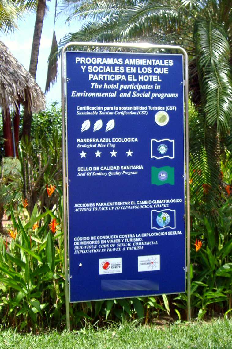 A hotel sign showing the voluntary certification programs the hotel has passed or is associated with. Shown are a four star Bandera Azul Ecológica and a three leaves CST Program.