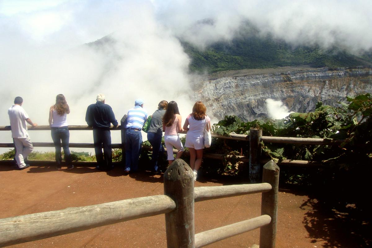 Tourists at the viewing area at the edge of the Poás Volcano crater.