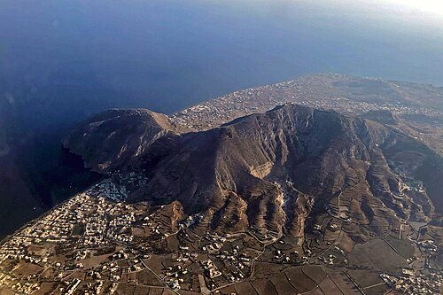 Aerial view of the island of Santorini with detail of Mount Profitis Illas and the ruins of ancient Thera (on the promontory on the left)
