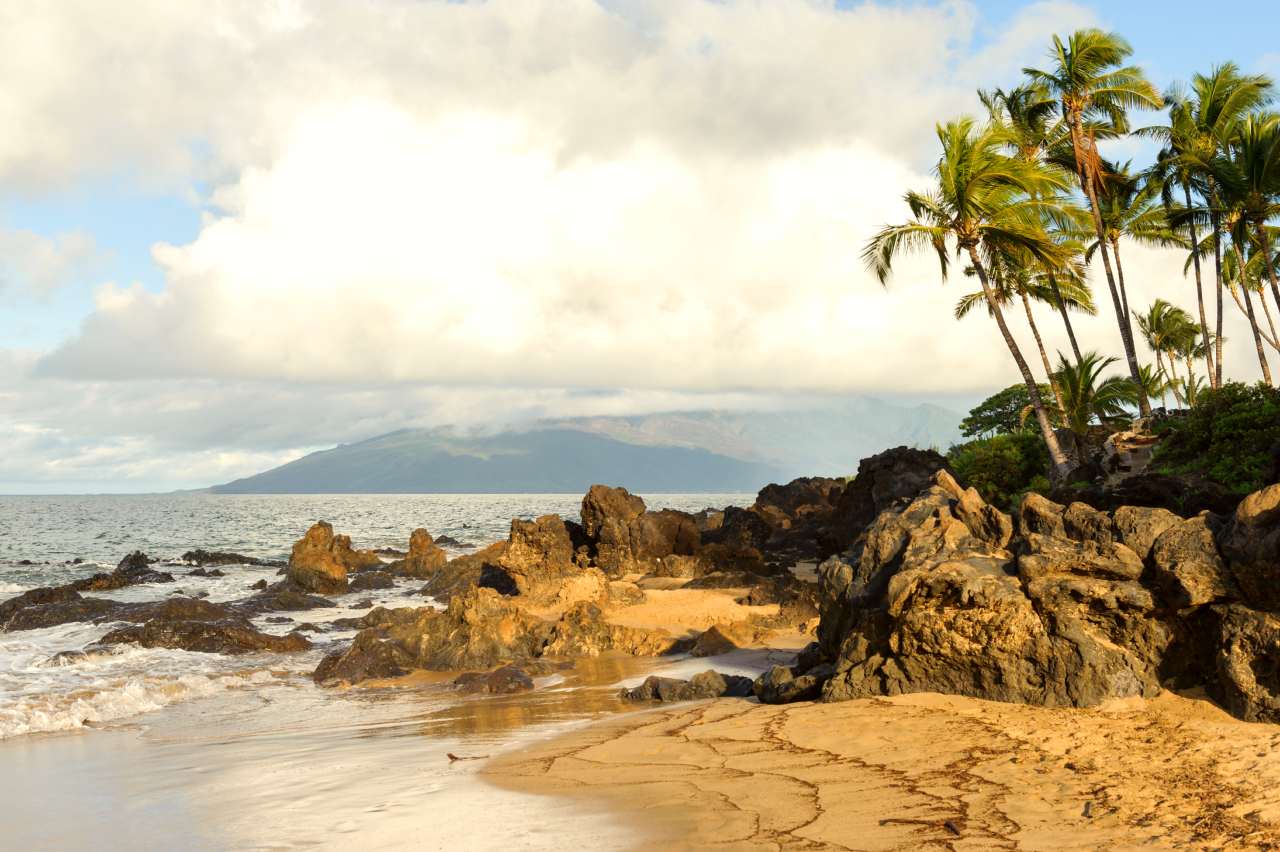 Volcanic rocks protrude on a Maui beach