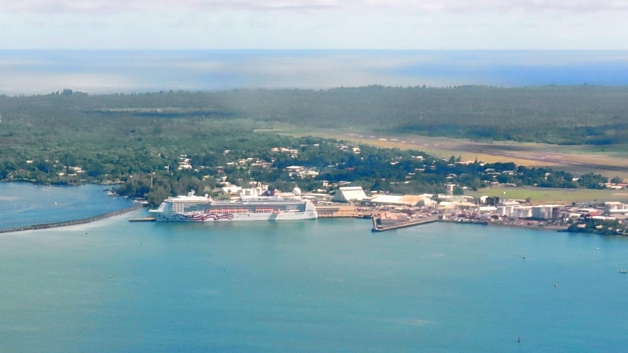 Pride of America docked at Hilo Harbor; Hilo International Airport runway is visible in the background